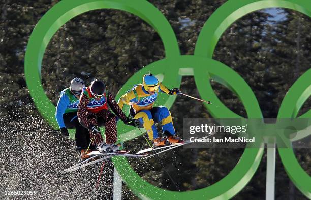 Filip Flisar of Slovenia, Christopher Delbosco of Canada and Tommy Eliasson of Sweden compete in a men's ski cross race on day ten of the Vancouver...