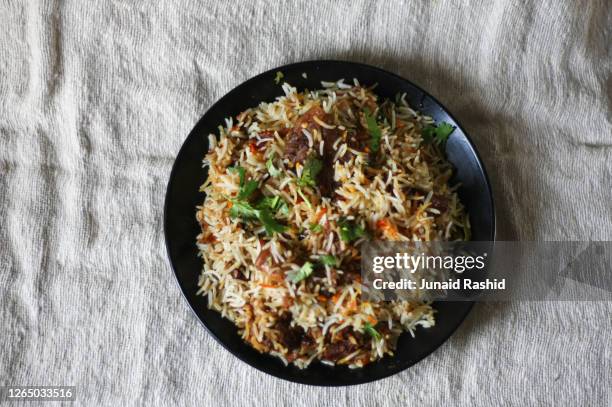 biryani beef and mutton rice closeup with garnish - biryani stock-fotos und bilder