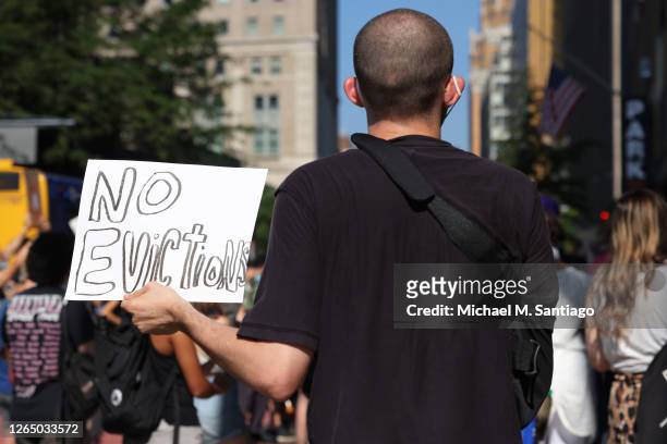 Demonstrator holds up a sign as he listens to speakers during a 'Resist Evictions' rally to protest evictions on August 10, 2020 in New York City....