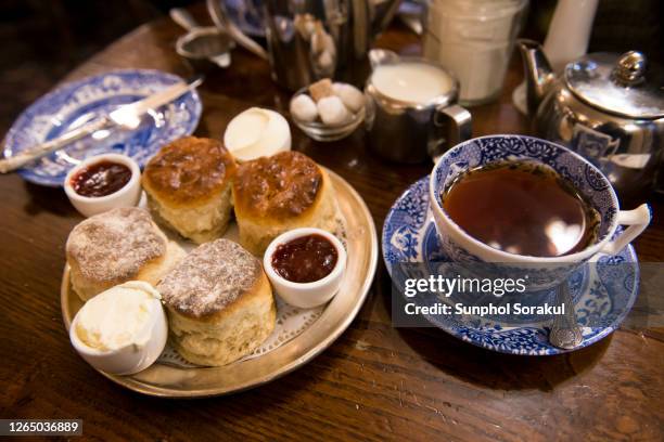 a traditional afternoon english tea set with scones - english afternoon tea stock pictures, royalty-free photos & images