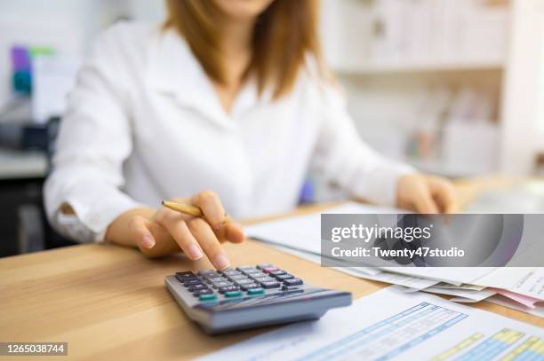 financial auditor analyzing company financial report concept of accounting, accountancy and tax form - income tax stock-fotos und bilder
