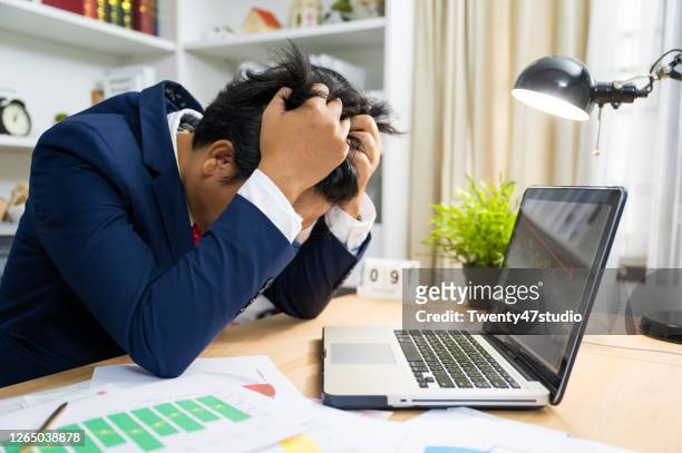 depressed business person has financial problems due to overpaying and company bankruptcy while coronavirus pandemic - crime board stock pictures, royalty-free photos & images