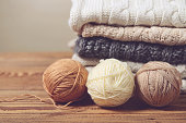 stack of sweaters on a wooden table