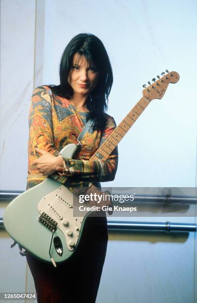 Studio portrait of Meredith Brooks posing with Fender Stratocaster guitar, SAS Hotel, Brussels, Belgium, 14 November 1997.