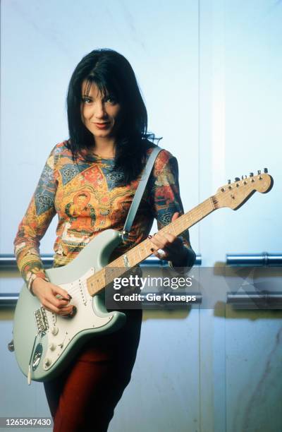 Studio portrait of Meredith Brooks posing with Fender Stratocaster guitar, SAS Hotel, Brussels, Belgium, 14 November 1997.