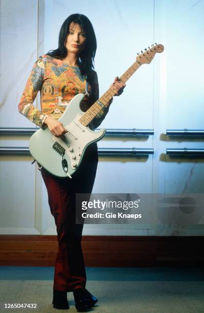 Studio portrait of Meredith Brooks posing with Fender Stratocaster guitar, SAS Hotel, Brussels, Belgium, 14 November 1997.