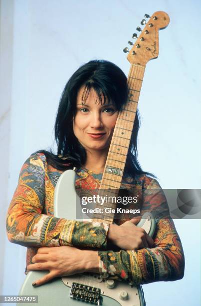 Studio portrait of Meredith Brooks posing with Fender Stratocaster guitar, SAS Hotel, Brussels, Belgium, 14 November 1997.