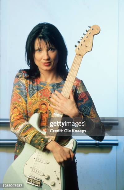 Studio portrait of Meredith Brooks posing with Fender Stratocaster guitar, SAS Hotel, Brussels, Belgium, 14 November 1997.