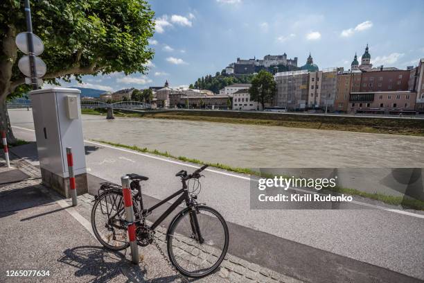 a bicycle parked in salzburg - rio salzach imagens e fotografias de stock