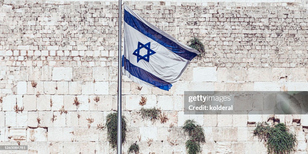 Israeli flag against Western Wall in Old City of Jerusalem