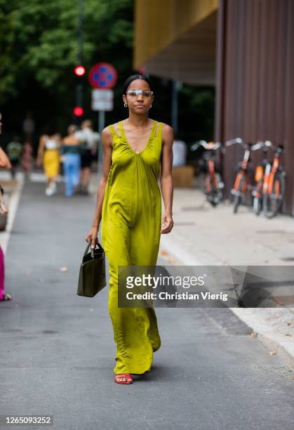 Guest is seen wearing silk dress outside 7 days active during Copenhagen Fashion Week SS21 on August 10, 2020 in Copenhagen, Denmark.