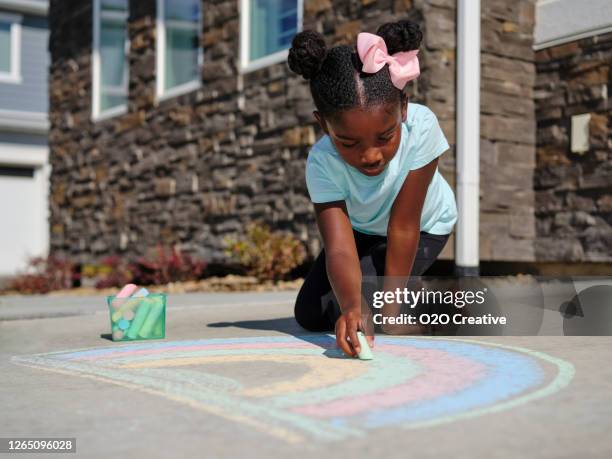 little girl drawing with sidewalk chalk - sidewalk stock pictures, royalty-free photos & images