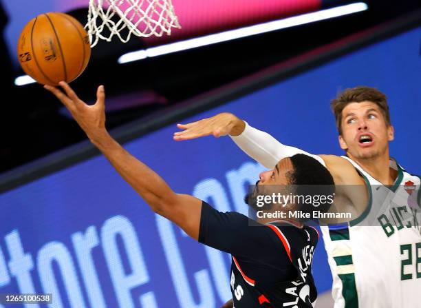 Norman Powell of the Toronto Raptors goes up for a shot against Kyle Korver of the Milwaukee Bucks during the second quarter at The Field House at...