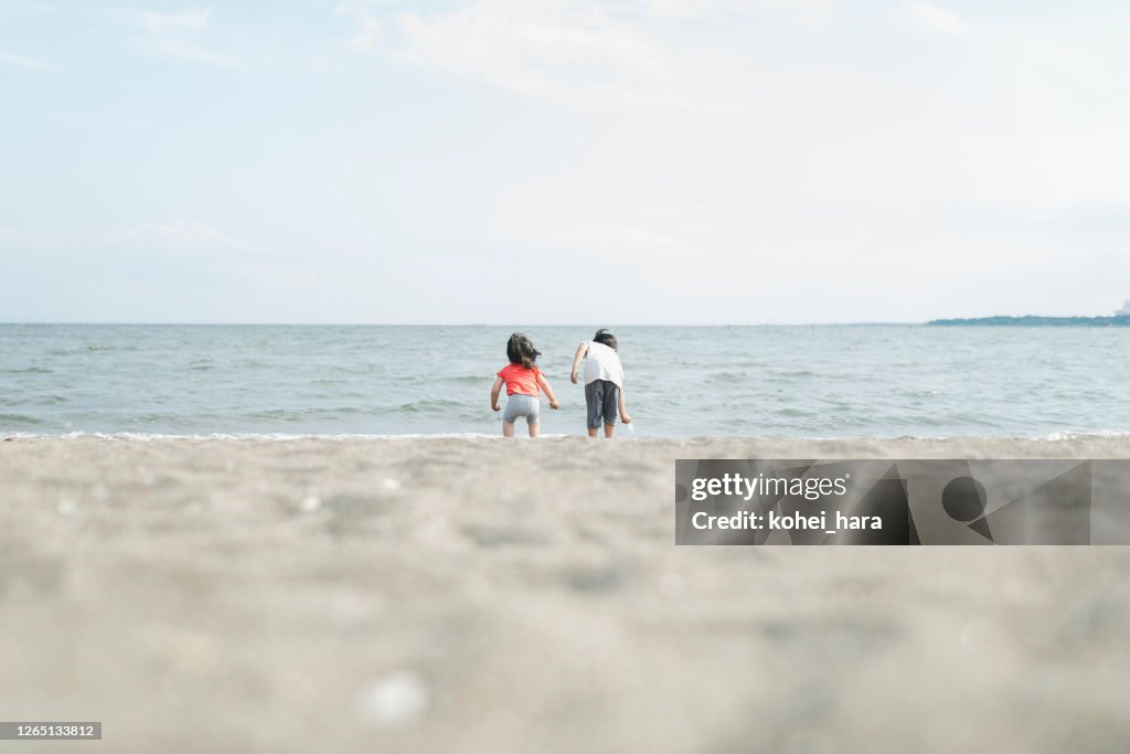 Fratello che gioca in spiaggia