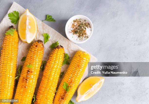 grilled sweet corn garnished with spicy salt and lemon ready to serve. baked corn served with lemon and spices, ready to eat. - sweetcorn stock pictures, royalty-free photos & images