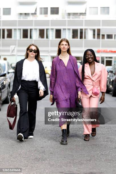 Influencer Sarah Lou Falk, wearing a white blouse by Resume Copenhagen, a black suit with white dots by Lala Berlin, white sneakers by Converse x...