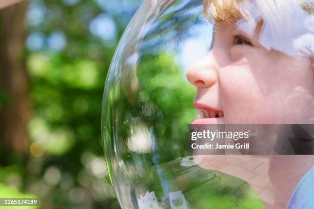 boy wearing bubble outdoors to socially distance - face shield stock-fotos und bilder