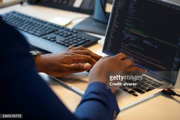 computer programmer working on laptop - software developer stock pictures, royalty-free photos & images