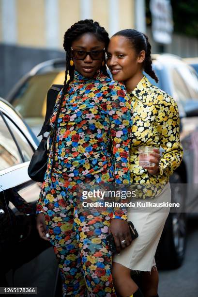 Two girls outside Ganni wearing colorful outfit and long boots during Copenhagen fashion week SS21 on August 10, 2020 in Copenhagen, Denmark.