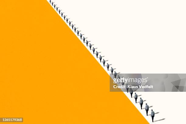 young men walking in row with shadows - multiple images of the same person stock pictures, royalty-free photos & images