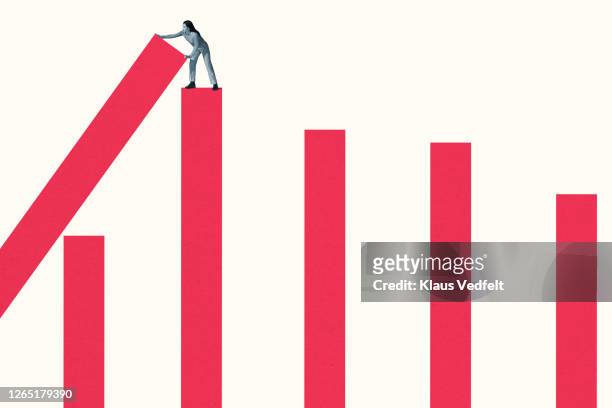 young woman building large pink bar graphs - picking up stock pictures, royalty-free photos & images