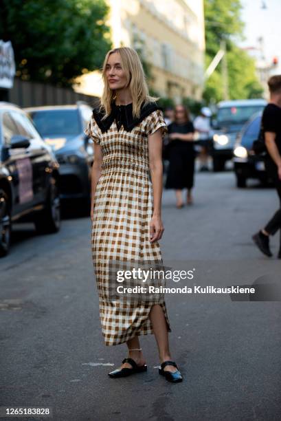 Marie Hindkær outside Ganni wearing withe and brown checked dress during Copenhagen fashion week SS21 on August 10, 2020 in Copenhagen, Denmark.