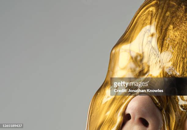 gold makeup dripping on face - metalic make up stock pictures, royalty-free photos & images