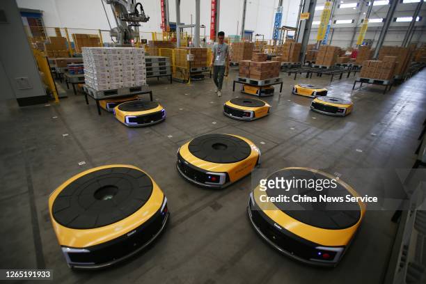 Staff member adjusts the AGV robot at the Suning Unmanned Logistics Warehouse on August 11, 2020 in Nanjing, Jiangsu Province of China.
