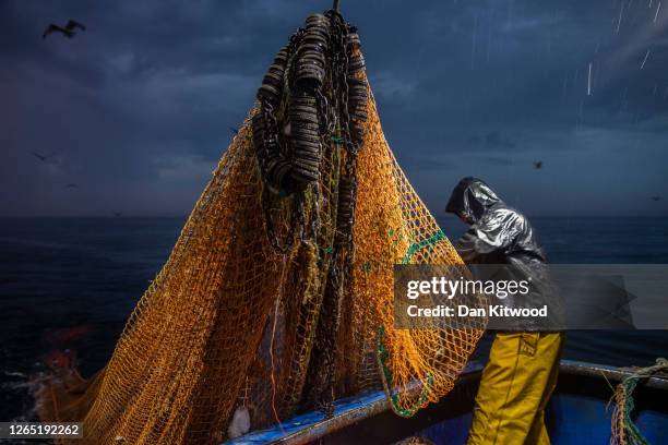 Skipper Stuart Hamilton, pulls in the nets while fishing for flatfish such as Skate and Dover Sole in the English Channel from a Hastings fishing...