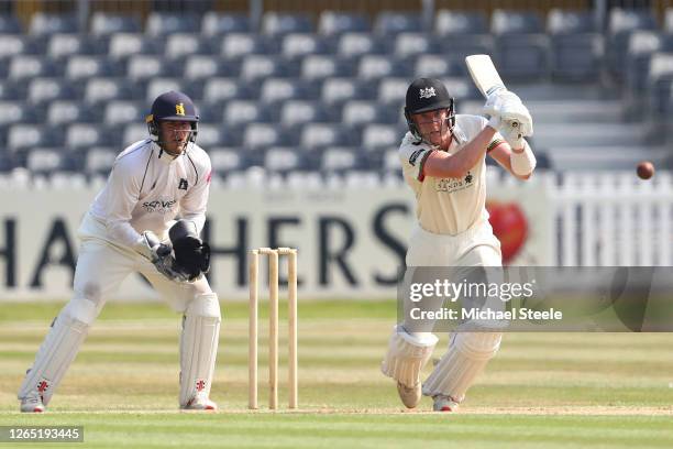 George Scott of Gloucestershire plays to mid off as Warwickshire wicketkeeper Michael Burgess looks on during day four of the Bob Willis Trophy...