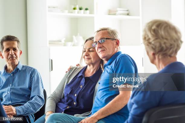senior people sharing issues during meeting - group therapy stock pictures, royalty-free photos & images