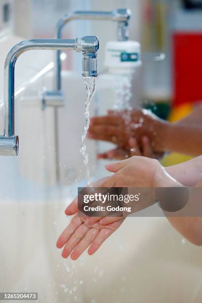 Nurse washing hands in medical aera. Cardiology hospital. Ho Chi Minh City. Vietnam.