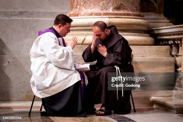 Penitentiary fathers confess the faithful during the celebration of Penance in St Peter's basilica at the Vatican.