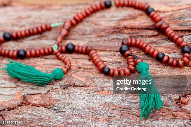 Muslim wooden prayer beads on a trunk.