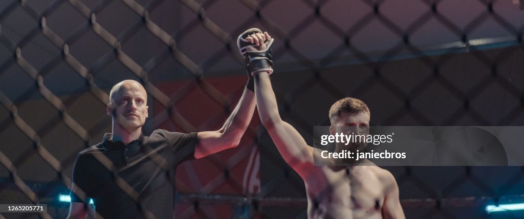 Referee declairing the winner after the mma fight. Inside octagon