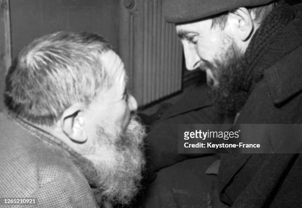 Abbe PIERRE speaking with a homeless man in 1954.
