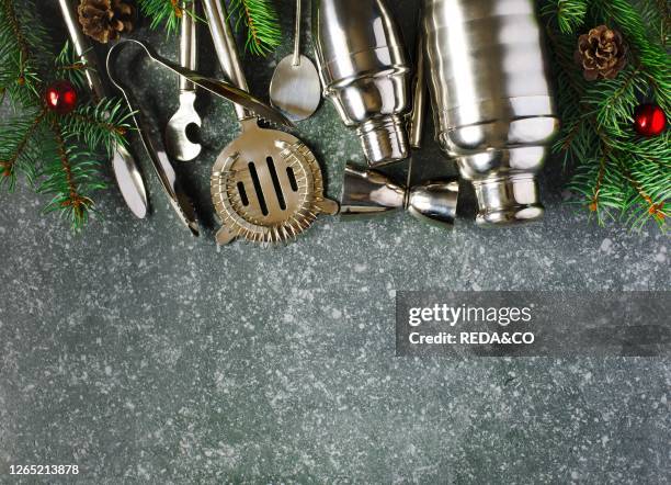 Set of bar tools and ingredients for making a cocktails arranged on a stone background. Copy space. Christmas concept.