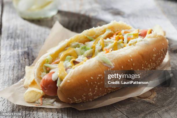 creamy coleslaw hotdog with mustard and potato chips - coleslaw stock pictures, royalty-free photos & images