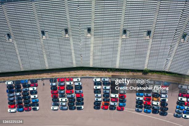 Used cars are stored next to the grandstand at the former Rockingham Race Track on August 11, 2020 in Corby, England. The site is owned by Rockingham...