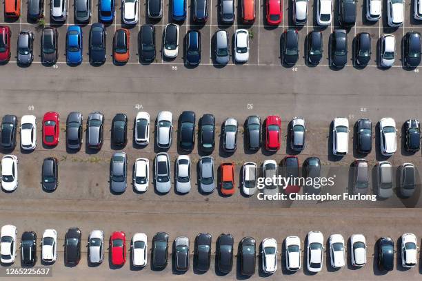 Cars are stored at the former at a giant holding area on August 11, 2020 in Corby, England. Vehicle leasing and hire companies saw a massive slump...