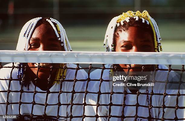 Teenage tennis sisters from America, Venus and Serena Williams take time off a practise session to pose together during the Adidas International...