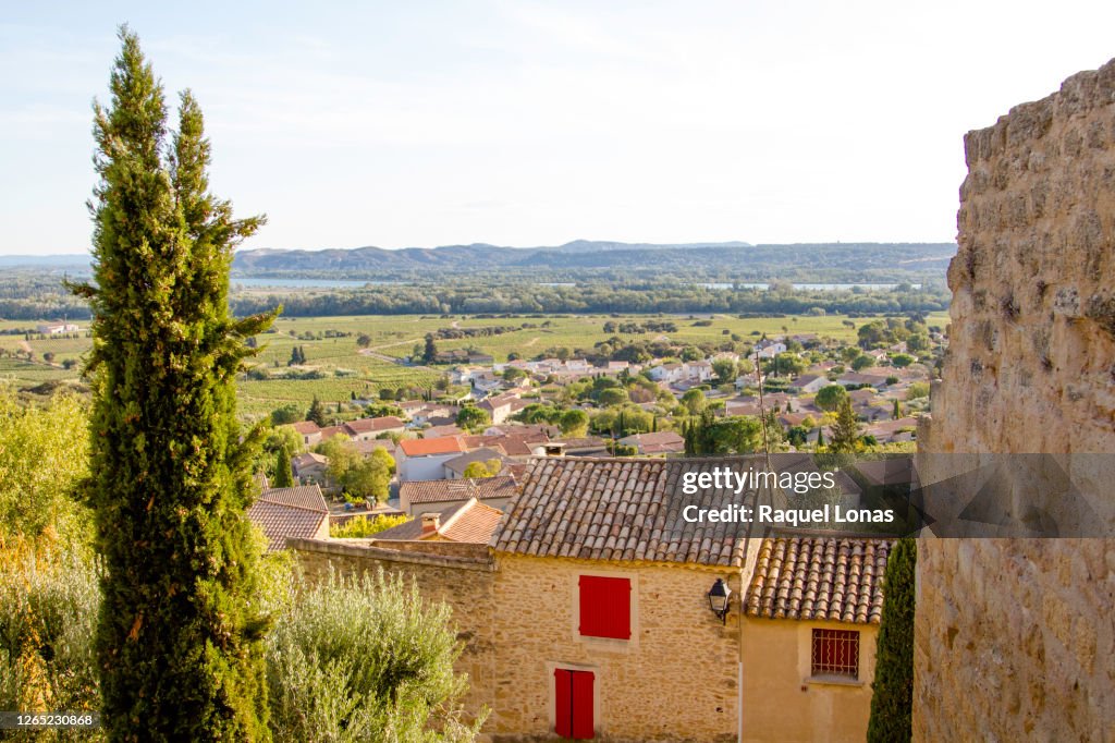 Looking over the Rhone Valley and village of Chateauneuf-du-Pape. Ancient ruins of castle wall on right side