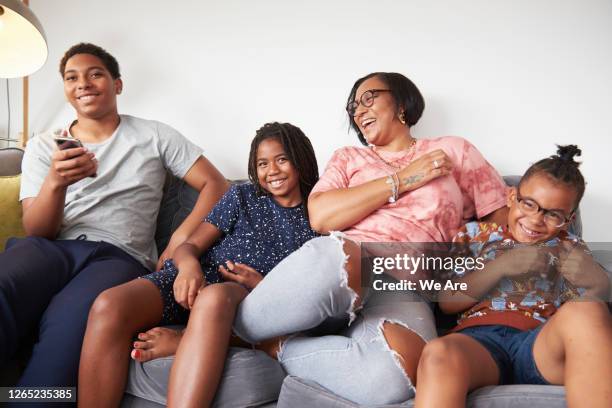 family bonding at home on sofa - fashionable mom stock pictures, royalty-free photos & images