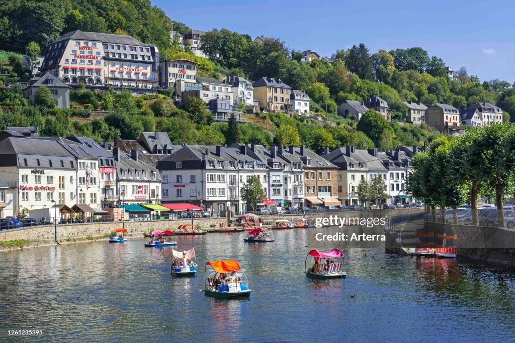 Paddle boats with tourists on the Semois river in the city Bouillon in summer.