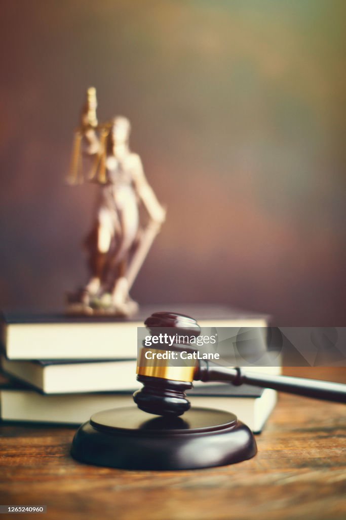 Gavel on desk with Lady Justice
