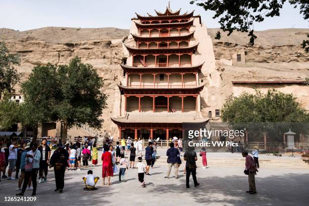 Chinese tourists in front of the Mogao Buddhist caves.