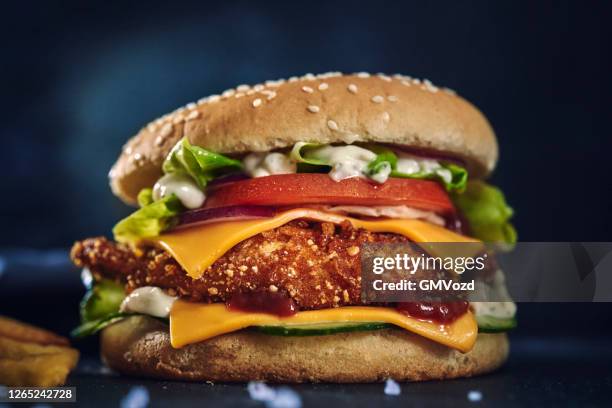 crispy chicken burger with cheese, tomato, onions and lettuce - cheesy fries stock pictures, royalty-free photos & images