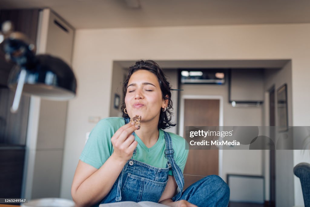 Girl enjoying her favorite cookie at home