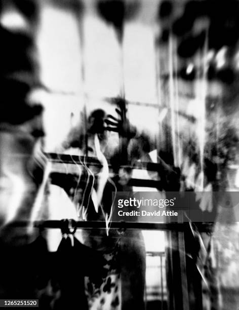 Photo montage of a man peering through a window, taken to illustrate the original publication of Truman Capote's "Breakfast At Tiffany's" in Harper's...