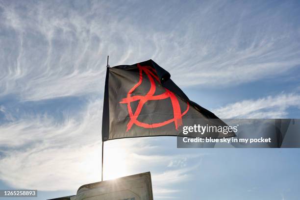 an anarchy flag blowing in the wind - símbolo da anarquia - fotografias e filmes do acervo